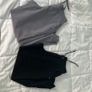 2 petite small Jaanuu scrub pants in light gray and black.